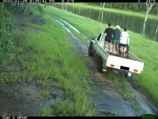 Photo of 3 young people standing on the back of a ute.
