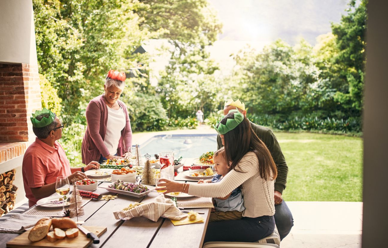 a happy family having Christmas lunch together at home outside