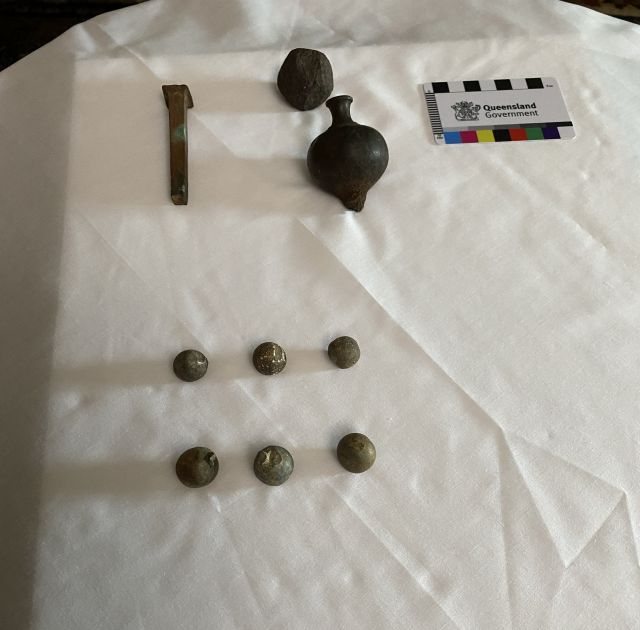 Photo of musket balls, a square nail and plum bob