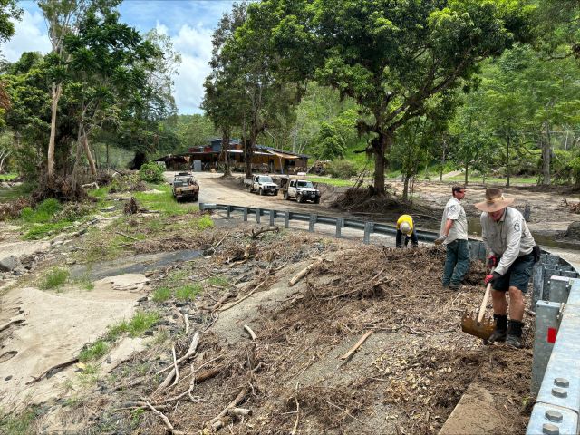 Photo of QPWS rangers who spent five days clearing fallen trees, mud and other debris from Wujal Wujal community spaces after ex-cyclone Jasper.