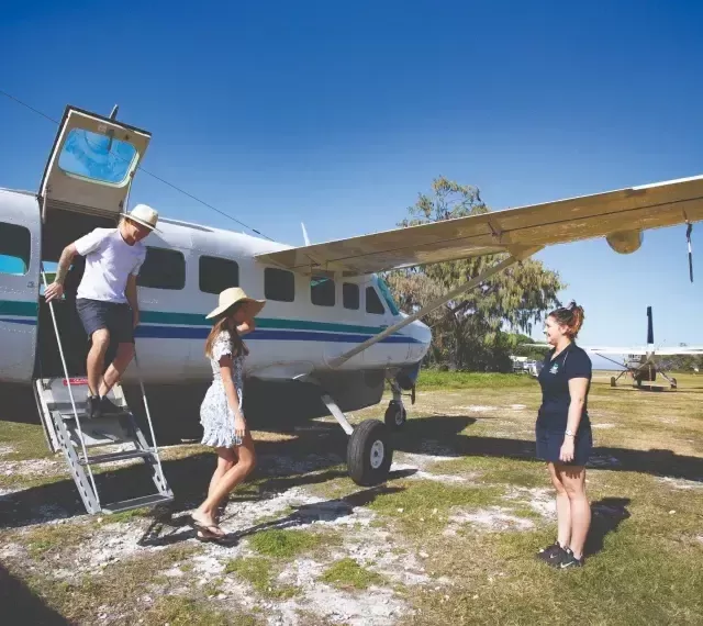 Photo of people disembarking from a light aircraft