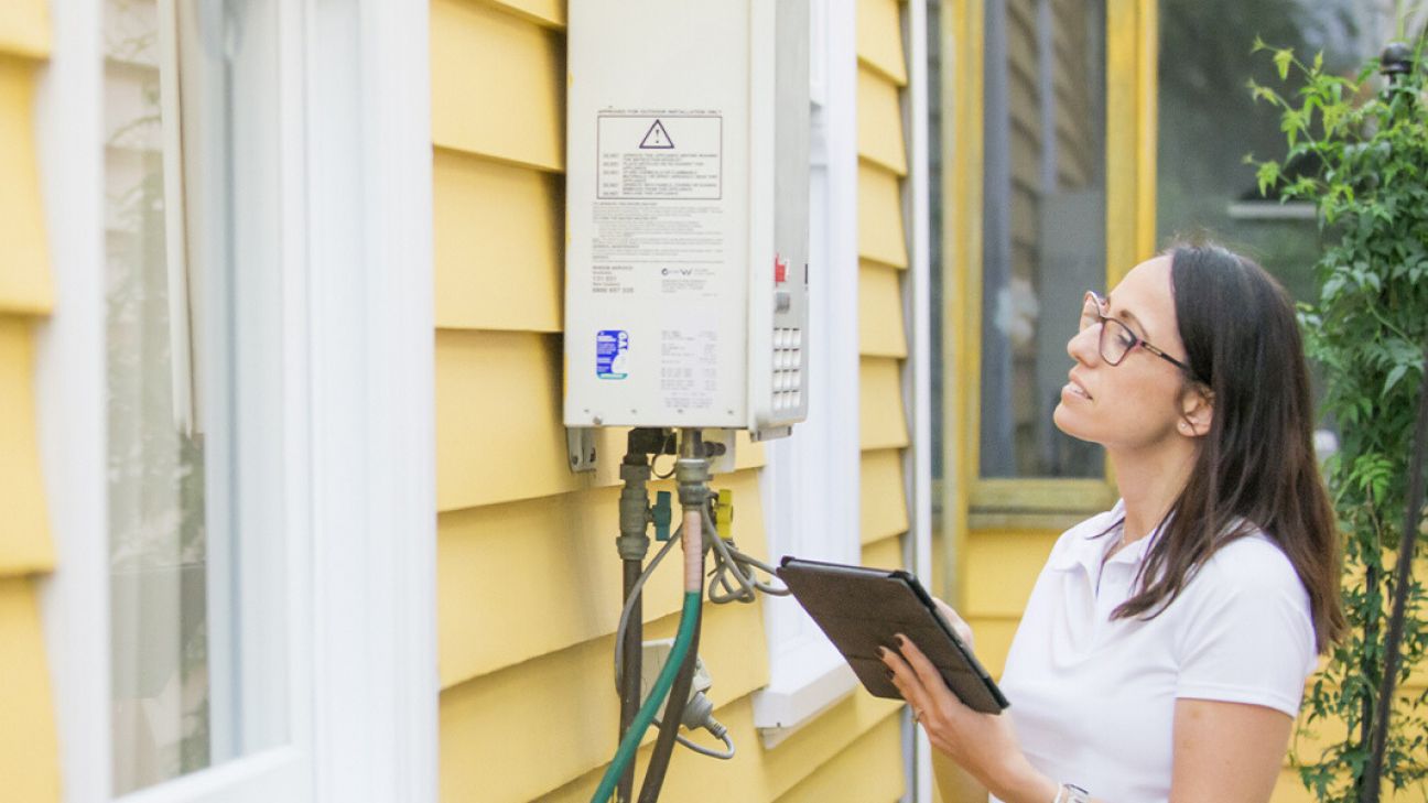 Person reviewing household energy use data while assessing opportunities to improve home energy efficiency.