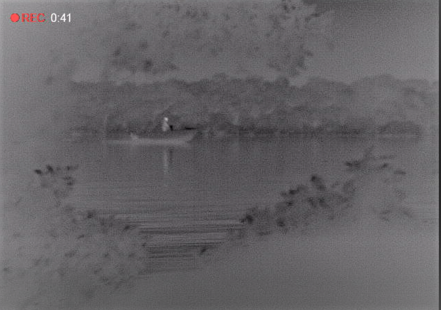 Photo of two men who were caught on surveillance inspecting crab pots that had been unlawfully set in the Green Zone.