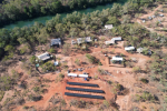 Aerial photo of the buildings of Boodjamulla (Lawn Hill) National Park ranger base with 3 rows of black solar panels visible