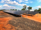 Photo of solar panel array at the Lakefield ranger base, with rich red dusty ground in the foreground and bright blue sky in the background.